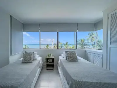 two beds in a room with a view of the ocean at Cartagena beach front in Cartagena de Indias
