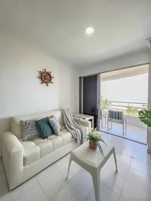 a living room with a white couch and a table at Cartagena beach front in Cartagena de Indias