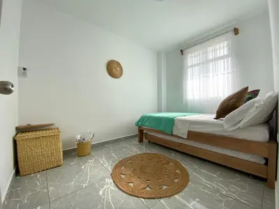a bedroom with a bed and a window at Apartamento en condominio con vista al mar in San Bernardo del Viento