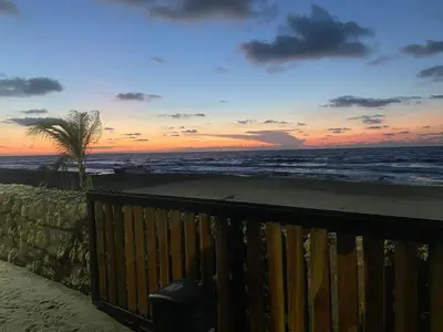 a view of the ocean at sunset from a balcony at Apartamento en condominio con vista al mar in San Bernardo del Viento