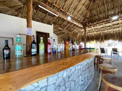 a bar with a bunch of bottles of alcohol at Apartamento en condominio con vista al mar in San Bernardo del Viento