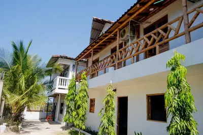 a building with trees in front of it at Cabañas en San Antero Bambumar2 in San Antero