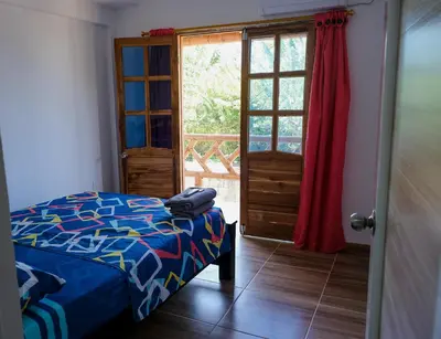 a bedroom with a bed and a door with a window at Cabañas en San Antero Bambumar2 in San Antero