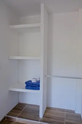a closet with white shelves and blue towels at Cabañas en San Antero Bambumar2 in San Antero