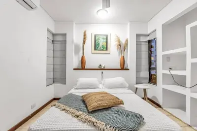 a bedroom with a bed with a blanket on it at Beachside Escape 2BR with Pool in Cartagena de Indias
