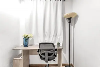 a desk with a chair next to a window at Beachside Escape 2BR with Pool in Cartagena de Indias