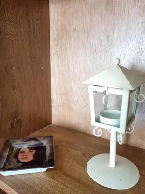 a doll house sitting on a table next to a magazine at Cabaña Amadeus cerca al mar in Coveñas
