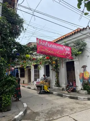 a building with a red sign on the side of it at Apartamento en Getsemaní in Cartagena de Indias