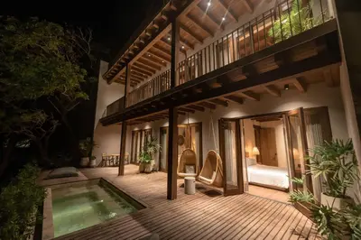 a house with a swimming pool on a wooden deck at Makani Luxury Cartagena in Tierra Bomba