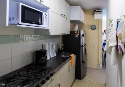 a kitchen with a black refrigerator and a microwave at Apartamento Cielo Cartagena in Cartagena de Indias
