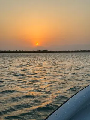 a sunset on the water from a boat at Tequila SunBeach Baru Eco-Hotel in Baru