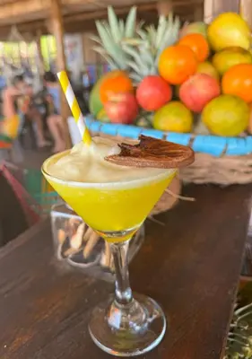 a drink sitting on a table with a straw at Tequila SunBeach Baru Eco-Hotel in Baru