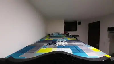 a bedroom with a bed with a colorful at HOSTAL EL ALTISIMO in Cartagena de Indias