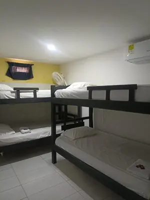 a dorm room with three bunk beds in it at HOSTAL EL ALTISIMO in Cartagena de Indias