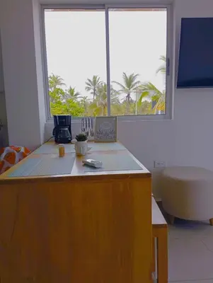 a room with a counter with a large window at NAHIR apartamento de playa en condominio Palmar del viento in San Bernardo del Viento