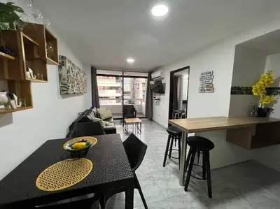 a kitchen and living room with a table and chairs at Apartamento -Laguito-Bocagrande in Cartagena de Indias