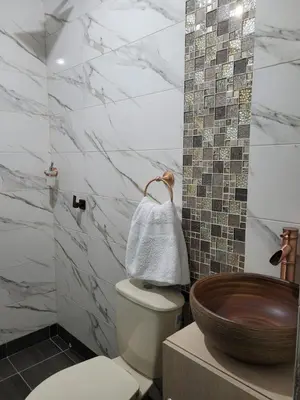 a bathroom with a toilet and a wooden sink at Apartahotel Los Ángeles in Cartagena de Indias