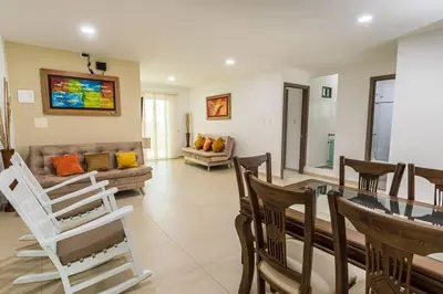 a living room with a table and chairs and a couch at Makadamia Aptos in Sincelejo