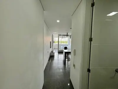 a hallway with white walls and a table in a room at Apartamento en Laguito Ed. Cristoforo 303 ICDI in Cartagena de Indias