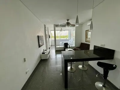 a room with a table and a living room at Apartamento en Laguito Ed. Cristoforo 303 ICDI in Cartagena de Indias