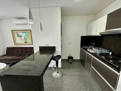 a kitchen with a black counter top in a room at Apartamento en Laguito Ed. Cristoforo 303 ICDI in Cartagena de Indias