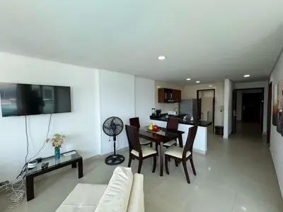 a living room with a table and a dining room at Apartamento en Laguito Ed Torres del Lago 604 ICDI in Cartagena de Indias