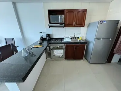 a kitchen with a refrigerator and a counter top at Apartamento en Laguito Ed Torres del Lago 604 ICDI in Cartagena de Indias