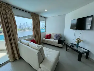 a living room with a couch and a large window at Apartamento en Laguito Ed Torres del Lago 604 ICDI in Cartagena de Indias