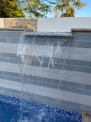 a water fountain with a flag painted on the side of a wall at CountrySide Stay Melina in San Mateo