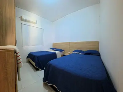 two beds in a room with blue sheets at CountrySide Stay Melina in San Mateo