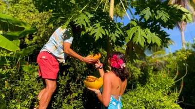 a man and a woman holding a bunch of bananas at Deluxe Family Suite - In front of the sea in Moñitos
