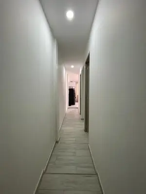 a hallway with white walls and a tile floor at Campiña Stay Apartamento Amoblado in Cartagena de Indias
