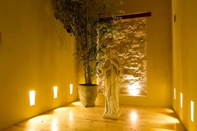 a room with a vase with a plant in it at Bastión Luxury Hotel in Cartagena de Indias