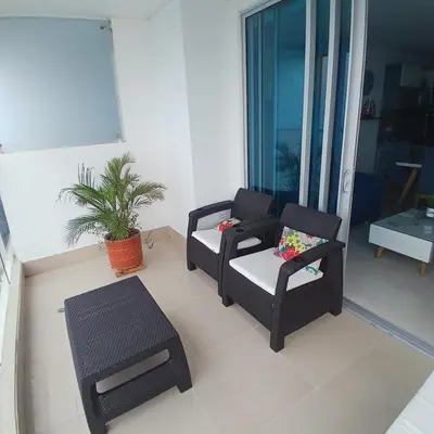 a living room with two chairs and a table at Apartamento 3404 Palmetto Beach Frente a la playa in Cartagena de Indias