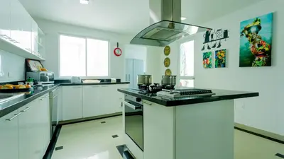 a kitchen with white cabinets and a counter top at Penthouse Marea Con Jacuzzi Privada Vista Mar in Cartagena de Indias