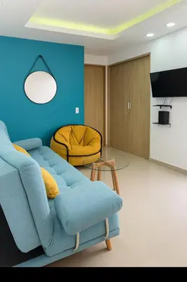a living room with a blue couch and a yellow chair at Lindo apto vista al mar,central y piscina rooftop in Cartagena de Indias