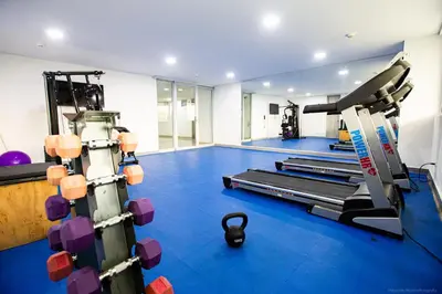a gym with several tread machines in a room at Confortable Apartamento Ocean Drive 711 -estancia mínima 2 noches- in Cartagena de Indias