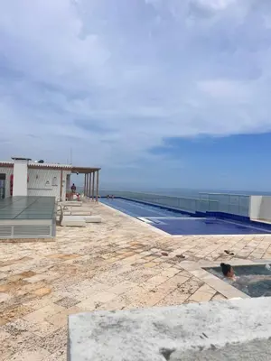 a swimming pool with a view of the ocean at Confortable Apartamento Ocean Drive 711 -estancia mínima 2 noches- in Cartagena de Indias