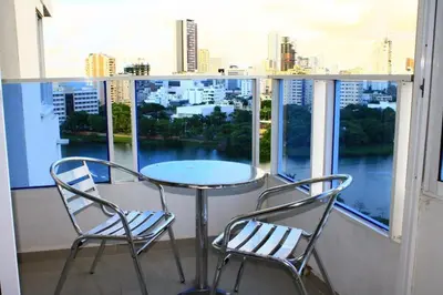 a table and two chairs on a balcony with a view at Apartamento con vista al laguito y al mar in Cartagena de Indias