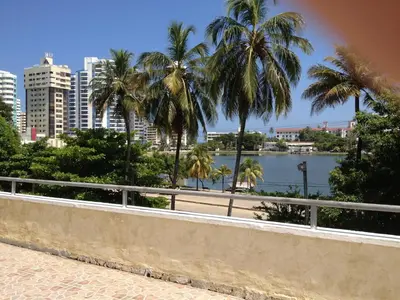 a view of a city with palm trees and a river at Apartamento con vista al laguito y al mar in Cartagena de Indias