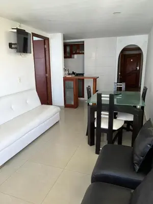 a living room with a couch and a table at Apartamento con vista al laguito y al mar in Cartagena de Indias