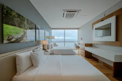 a hotel room with two beds and a television at Hotel InterContinental Cartagena by IHG in Cartagena de Indias