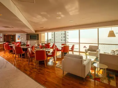 a restaurant with tables and chairs and a large window at Hotel InterContinental Cartagena by IHG in Cartagena de Indias