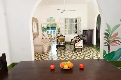 a living room with a table with a bowl of fruit on it at Casa Hotel Terraza del Cabrero in Cartagena de Indias
