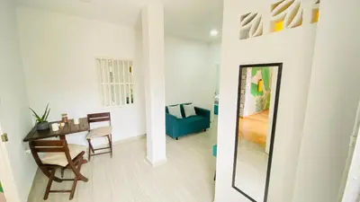a living room with a dining room table and a mirror at Casa Hotel Terraza del Cabrero in Cartagena de Indias