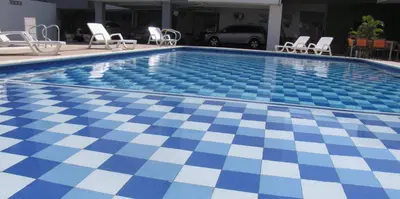 a swimming pool with a blue and white checkered floor at Hotel Mar del Plata in Cartagena de Indias