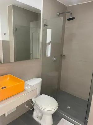 a bathroom with a toilet and a glass shower at Hotel Mar del Plata in Cartagena de Indias