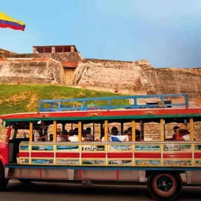 a bus full of people driving down the street at MoraRoom in Cartagena de Indias