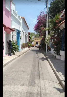 a man taking a picture of an empty street at MoraRoom in Cartagena de Indias
