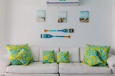 a white couch with pillows and pictures on the wall at Espectacular apartamento en Cartagena Seaway935 - Morros in Cartagena de Indias